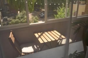 a bench sitting in front of a window at Algirdo Apartments, Self Check-in, Free Private Parking in Vilnius +41 photos