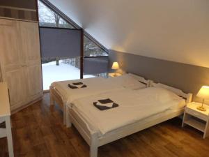 a bedroom with a white bed and a window at Chalet de Cligneval in Malmedy