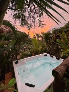 a hot tub sitting in the middle of a garden at The Valley Tayrona hostel- A social jungle hostel in El Zaino