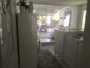 a kitchen with a white refrigerator in a room at Little White House in Anglet