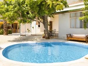 a large blue pool in front of a house at Sea Salt Inn in Kemer