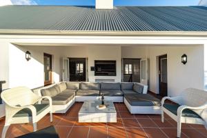 a living room with a couch and chairs at Winelands Golf Lodges 3 in Stellenbosch