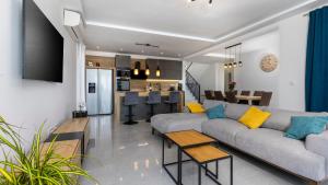 a living room with a couch and a kitchen at Villa Luminosa by Villas Guide in Kraljevica
