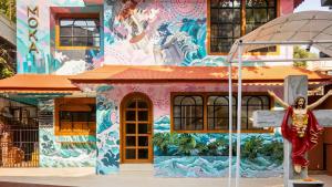 a colorful building with a statue in front of it at Sheetal Vaibhav 902 in Mumbai