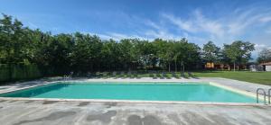 a swimming pool with lawn chairs at Chubini Winery & Cabins in Kvareli