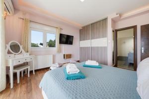 a bedroom with two beds and a sink and a mirror at Villa Sarakinos in Kriniás