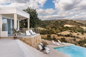 a villa with a swimming pool and a house at Elaia Bioglam Relais in Casa Modica