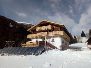 a log cabin in the snow with snow covered at Chalets Dolomiti living in Vergein
