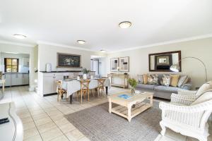 a living room with a couch and a table at Winelands Golf Lodges 10 in Stellenbosch