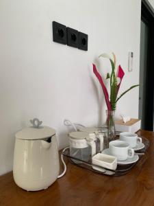 a table with a coffee maker and cups on it at Cozzy Sagas House Tabanan in Perean +10 photos