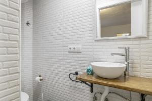 a white bathroom with a sink and a mirror at Vejer de la frontera 100 pza España in Vejer de la Frontera +14 photos