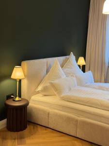 a bed with white pillows on it in a room at Westerntor City Studio in Paderborn