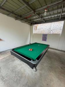 a garage with a pool table in a room at Itawis Resort - Nature Chalet in Silang +5 photos