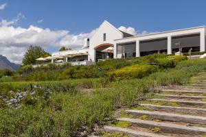 a house on top of a hill with stairs at Winelands Golf Lodges 10 in Stellenbosch