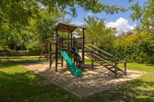 a playground with a slide in a park at Winelands Golf Lodges 10 in Stellenbosch