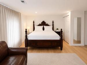 a bedroom with a large bed and a couch at Parkside luxury suite and EV station in Jenkintown