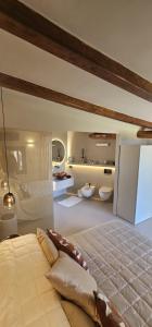 a bedroom with a large bed and two sinks at Residenza Grazia sul mare in Abbiadori +26 photos