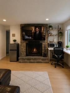 a living room with a fireplace with a flat screen tv at Parkside luxury suite and EV station in Jenkintown