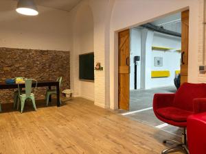 a room with a table and chairs and a wall at Ca La Fustereta in Figueres