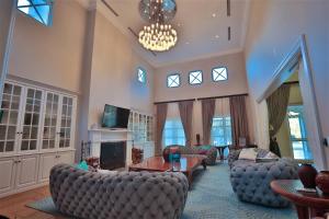 a large living room with couches and a chandelier at Private Manor Estate Fly Fishing Sleeps 18 in Dullstroom