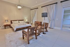a bedroom with a bed and a table and chairs at Private Manor Estate Fly Fishing Sleeps 18 in Dullstroom