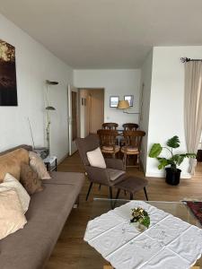 a living room with a couch and a dining room at Fewo Strandweg Überlingen in Überlingen