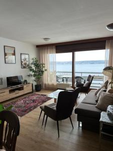 a living room with a couch and a table with chairs at Fewo Strandweg Überlingen in Überlingen