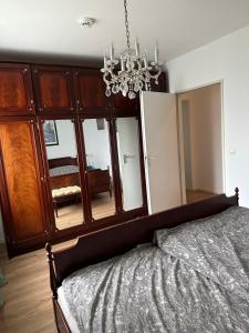 a bedroom with a bed and a chandelier at Fewo Strandweg Überlingen in Überlingen