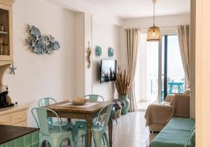 a kitchen and living room with a table and chairs at Mareluna Luxury Accomodation in Lampedusa
