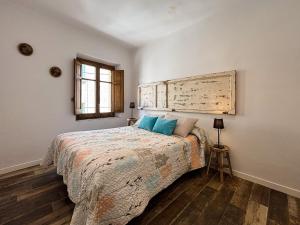 a bedroom with a large bed with a wooden headboard at Ca La Fustereta in Figueres