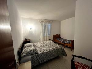 a small bedroom with a bed and a window at Les oliviers du pradon in Lagarde-Paréol