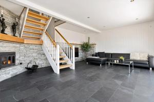 a living room with a couch and a fireplace at Beach House With Multiple Terraces In Holmsbu in Holmsbu