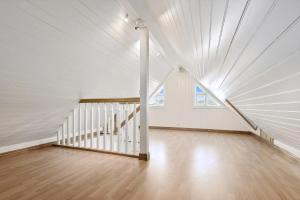 a white room with a staircase in a house at Beach House With Multiple Terraces In Holmsbu in Holmsbu +22 photos
