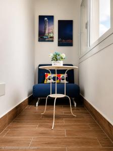 a table and a blue chair in a room at Sole E Mare in Marina di Fuscaldo