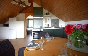 a kitchen with a table with a vase of flowers on it at Rose in Überlingen