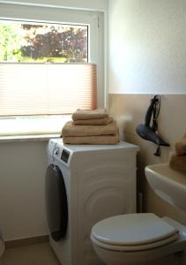 a bathroom with a white toilet and a window at Rose in Überlingen