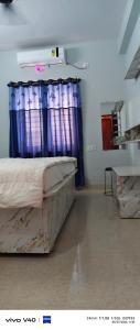 a hospital room with a bed and a window at Alliswell in Patna