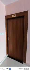 a wooden door with a sign on top of it at Alliswell in Patna