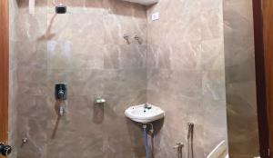 a bathroom with a sink and a shower at Alliswell in Patna