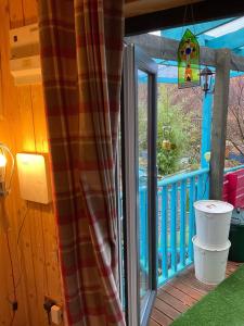 a porch with a sliding glass door to a deck at Sleeps 2 includes breakfast in Garve +2 photos