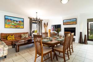 a living room with a table and chairs and a couch at Winelands Golf Lodges 14 in Stellenbosch