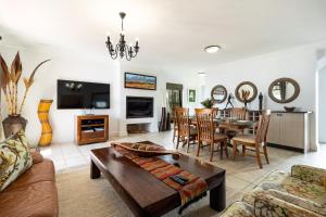 a living room with a couch and a table at Winelands Golf Lodges 14 in Stellenbosch