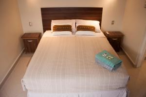 a bedroom with a bed with two pillows on it at Hostal Anpaymi Atacama in San Pedro de Atacama