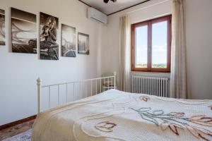 a bedroom with a white bed and a window at Casa Corniolo Near Arezzo in Monte San Savino