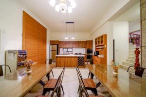 a kitchen with a long wooden table and chairs at Canova Homestay in Ji'an