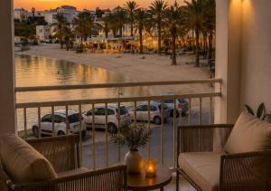 a balcony with a view of a parking lot with cars at Mareluna Luxury Accomodation in Lampedusa