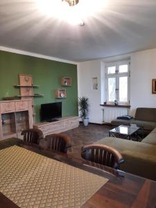 a living room with a couch and a fireplace at Ferienhaus Rötzer - Forsthausschmankerl mit Sauna, Whirlpool und Grill in Bruck in der Oberpfalz