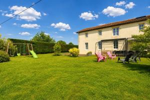 a yard with chairs and a swing at Gîte La Ferme Du Mesnil in Sevremont