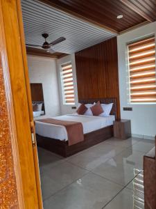 a bedroom with a large bed in a room at Merjin's Paraiso in Vagamon