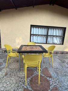a table and four chairs and a table and chairs at Meghdoot New Resort in Matheran